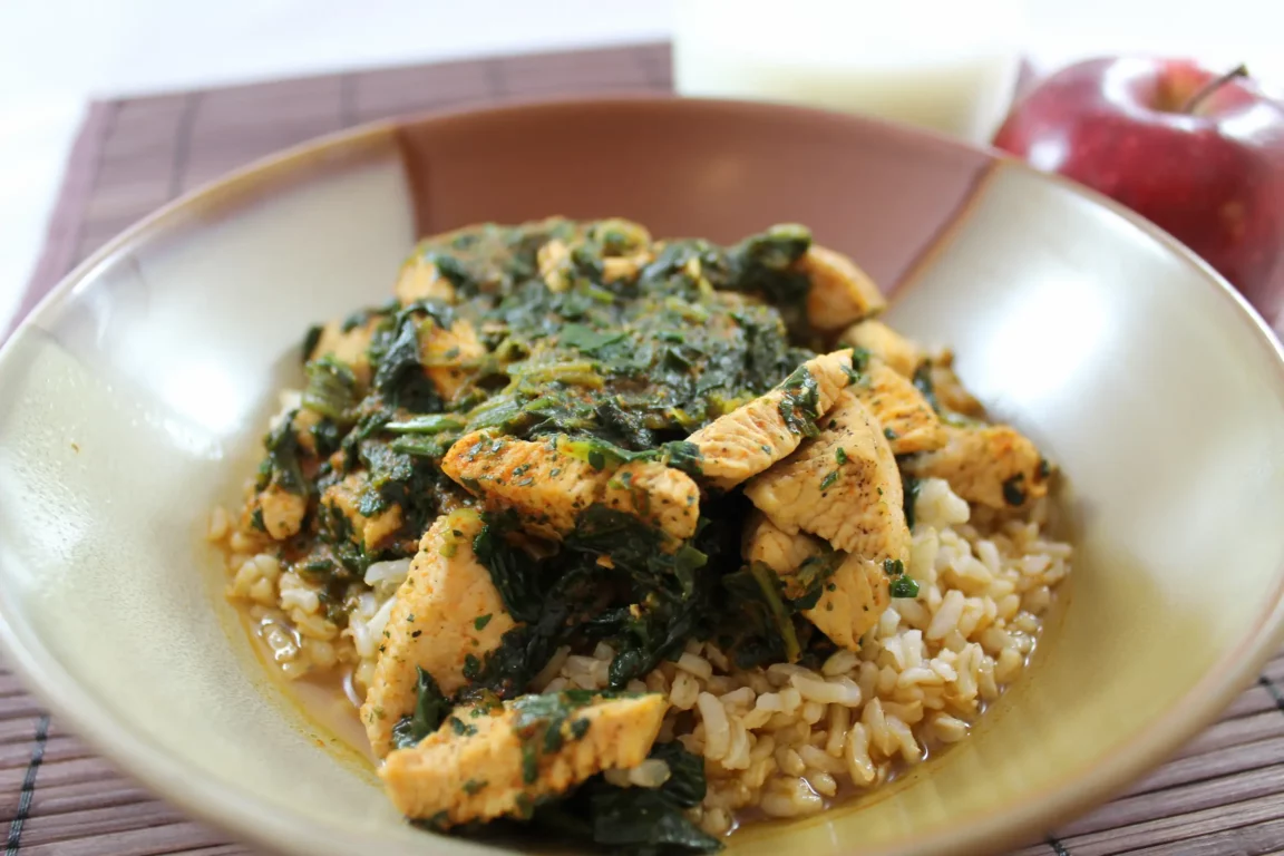 Curried chicken and spinach plated.
