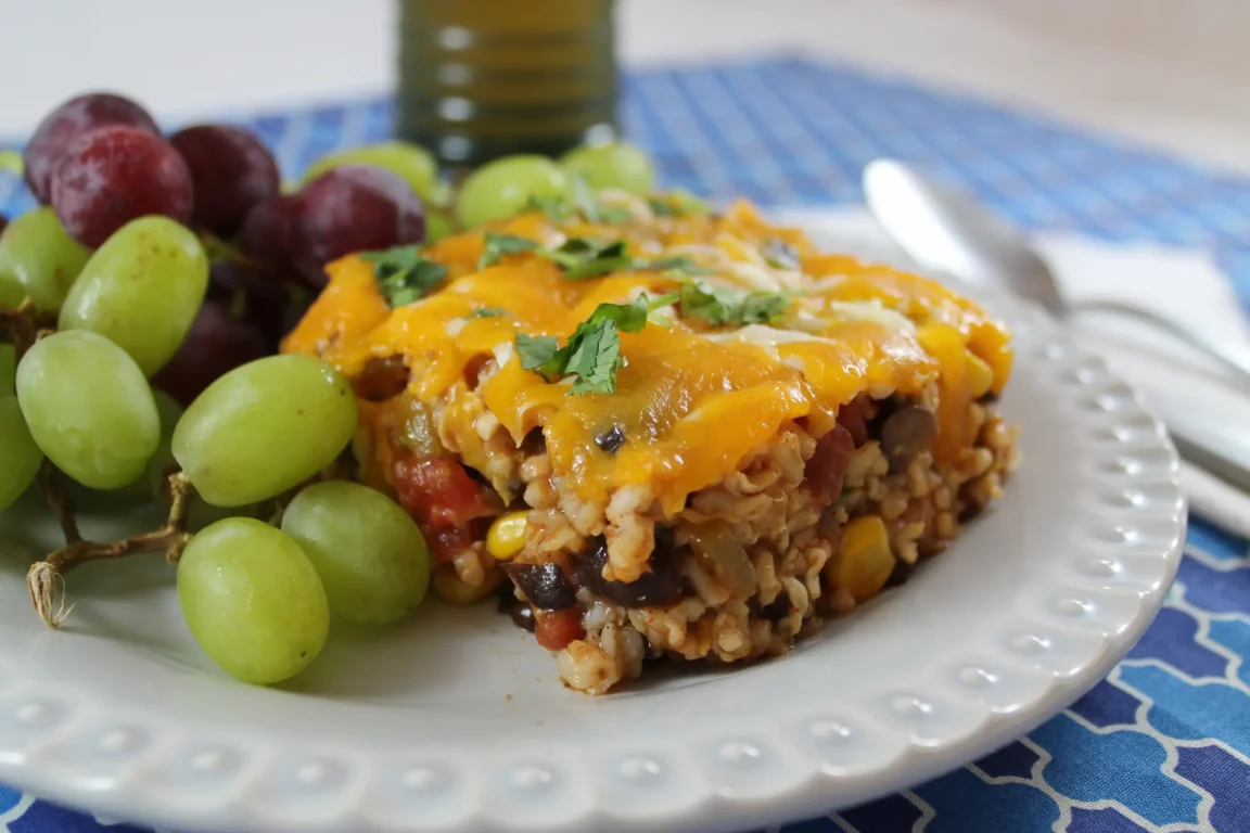 Fiesta casserole topped with melted cheese and cilantro