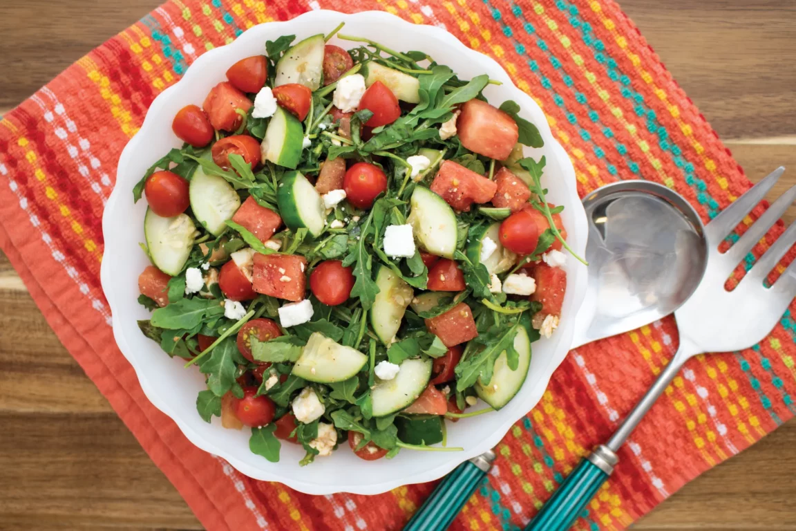 Plated salad with cucumber, watermelon, arugula and feta. 