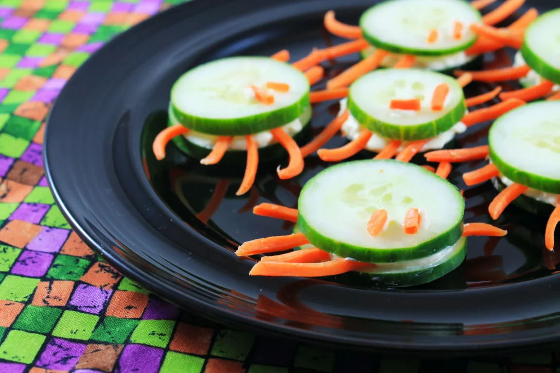 Cucumber and carrot spiders served on plate.