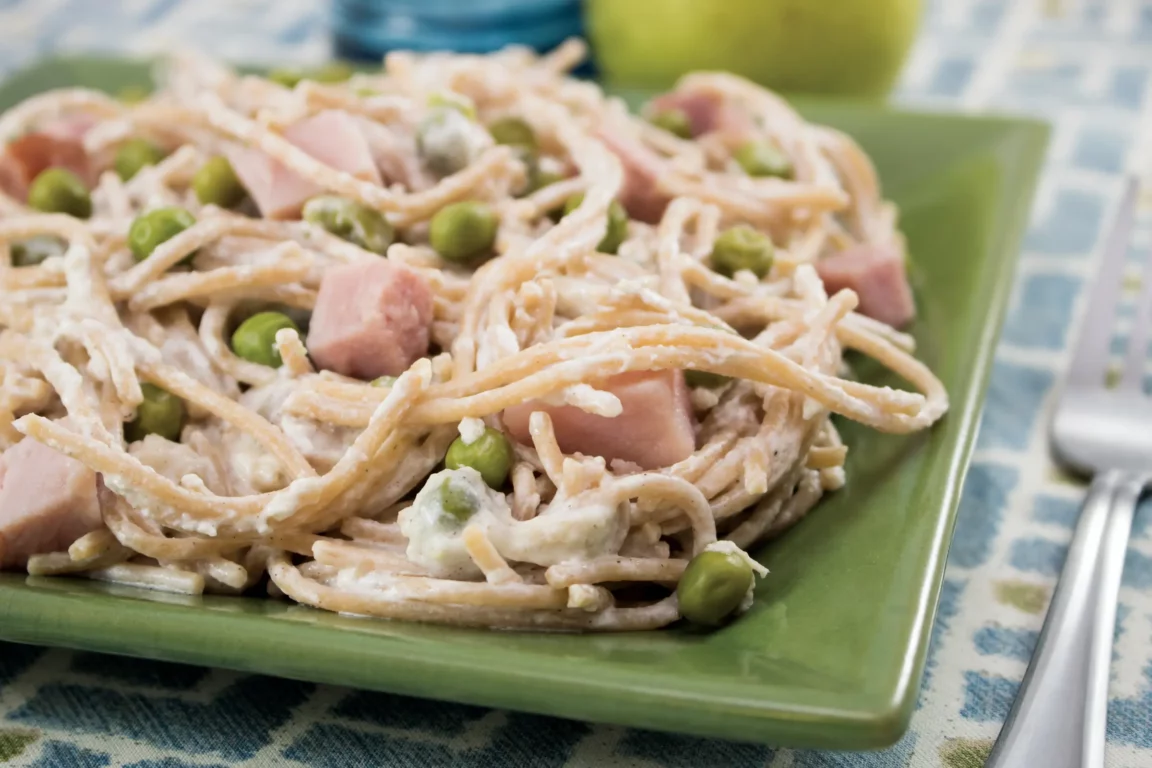 Creamy ham & pea pasta topped with parmesan 
