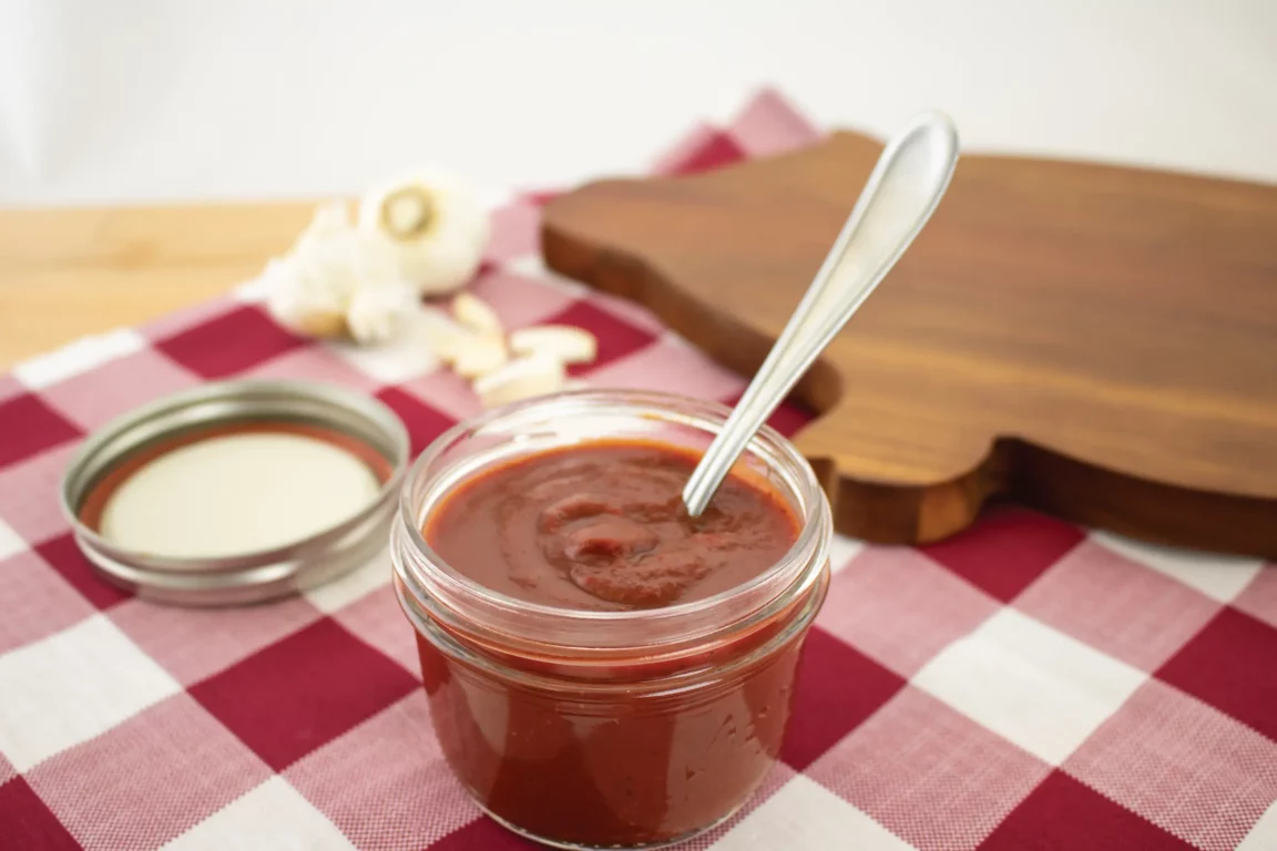 Cup Homemade BBQ sauce served with spoon