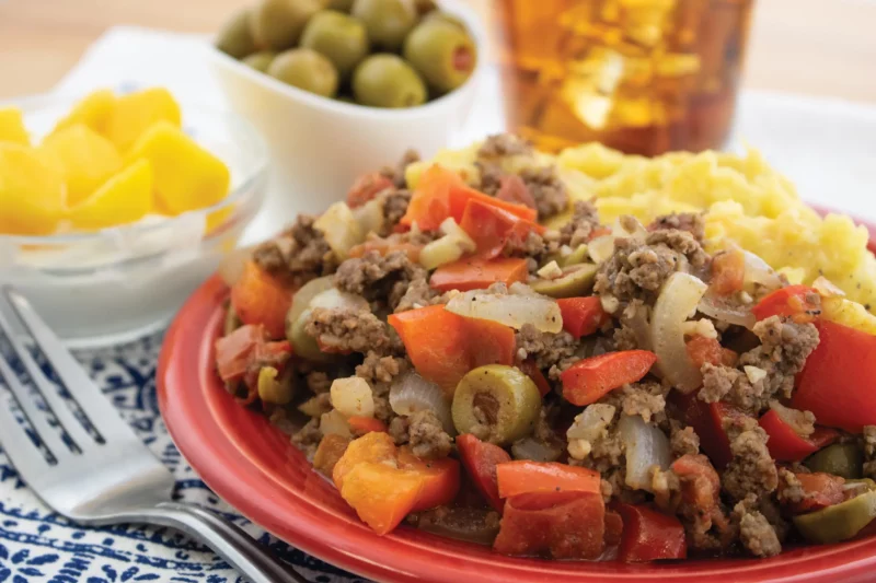 Beef picadillo plated with green olives