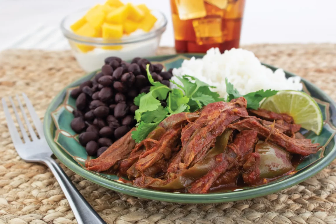 cuban ropa vieja plated with lime slices 