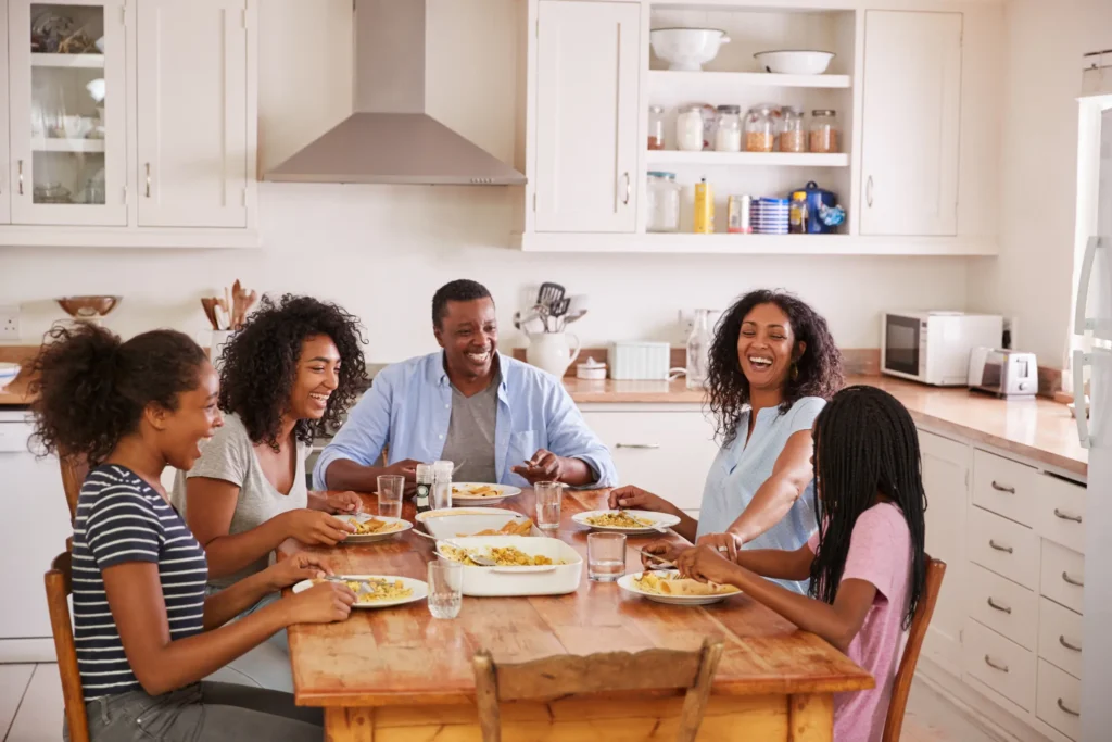 Family laughing at table.